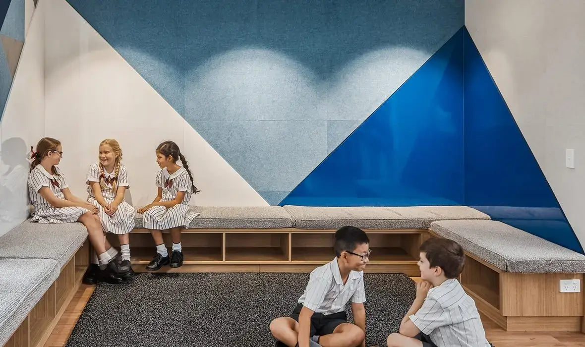 Students engaging in a quiet, collaborative learning space designed for focus and improved communication.