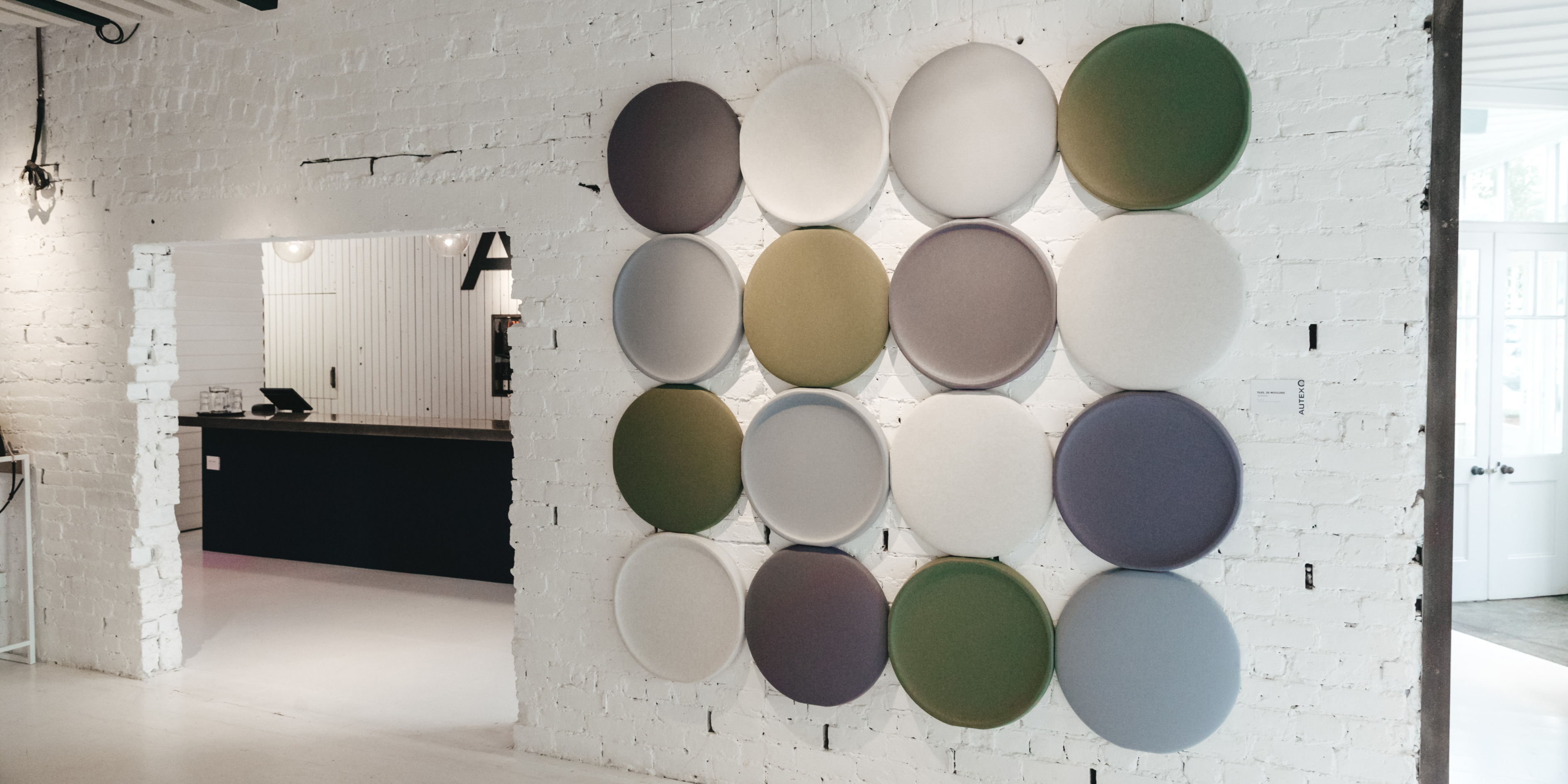 Stylish 3D acoustic panels in various colours enhancing a modern lounge space with soundproofing benefits.