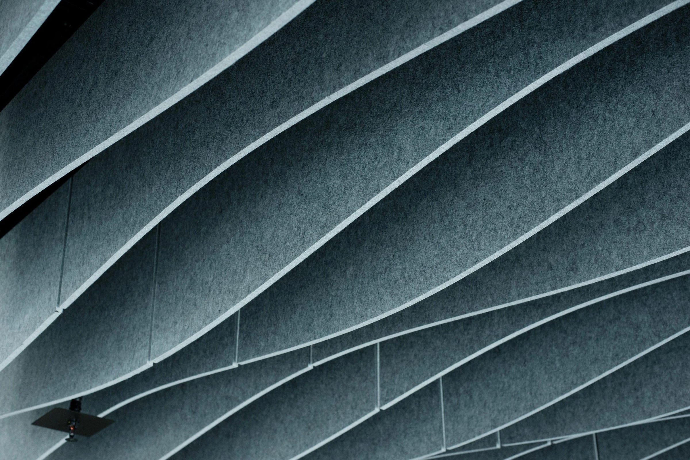 Acoustic ceiling panels in various colours, enhancing aesthetics and soundproofing in a modern interior space.