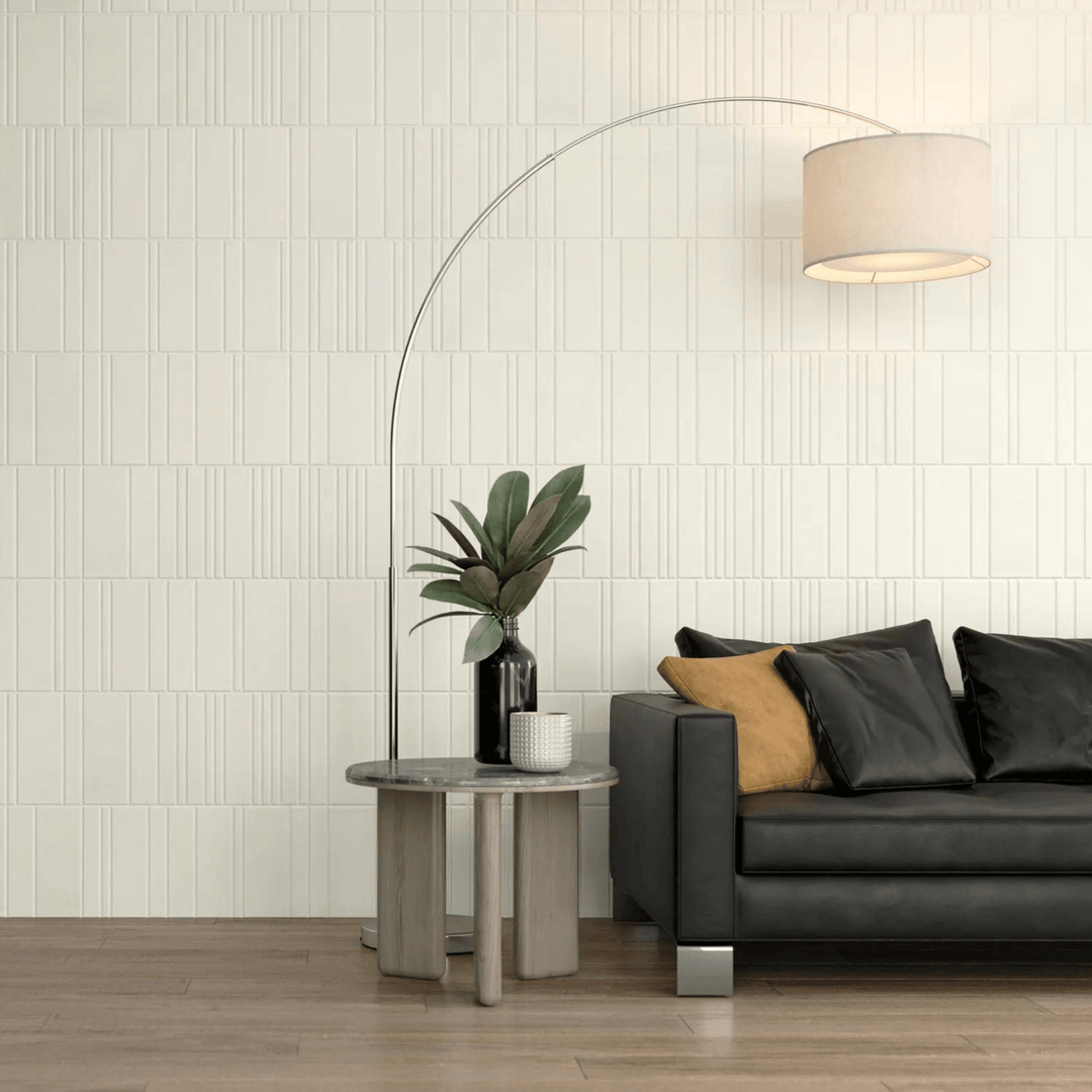 Modern living space featuring Acoufelt Fracture Acoustic Tiles with sleek sofa, architect lamp, and stylish decor accents.