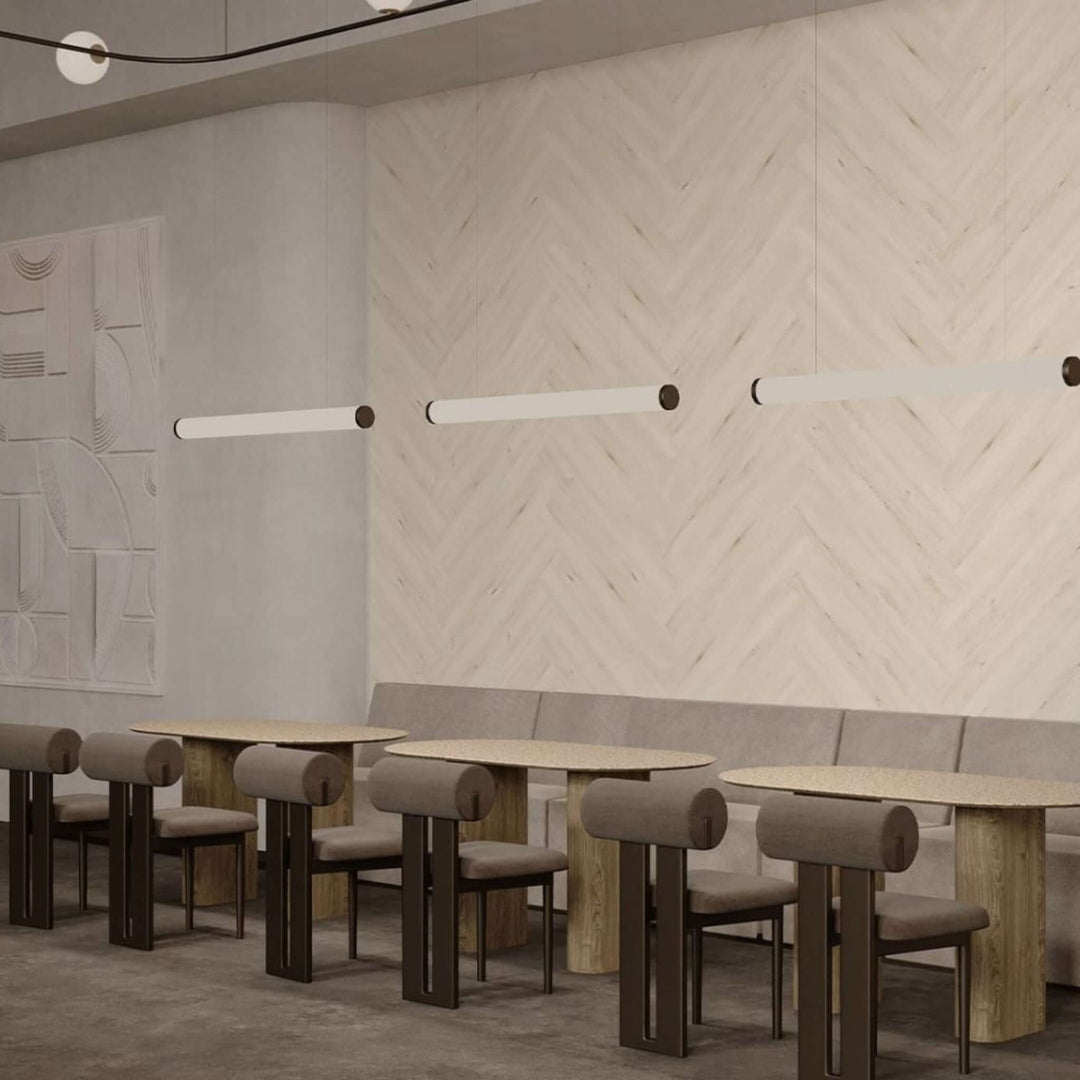 Modern café interior featuring Acoufelt WoodBeQuiet™ acoustic wall planks with herringbone design and stylish lighting.