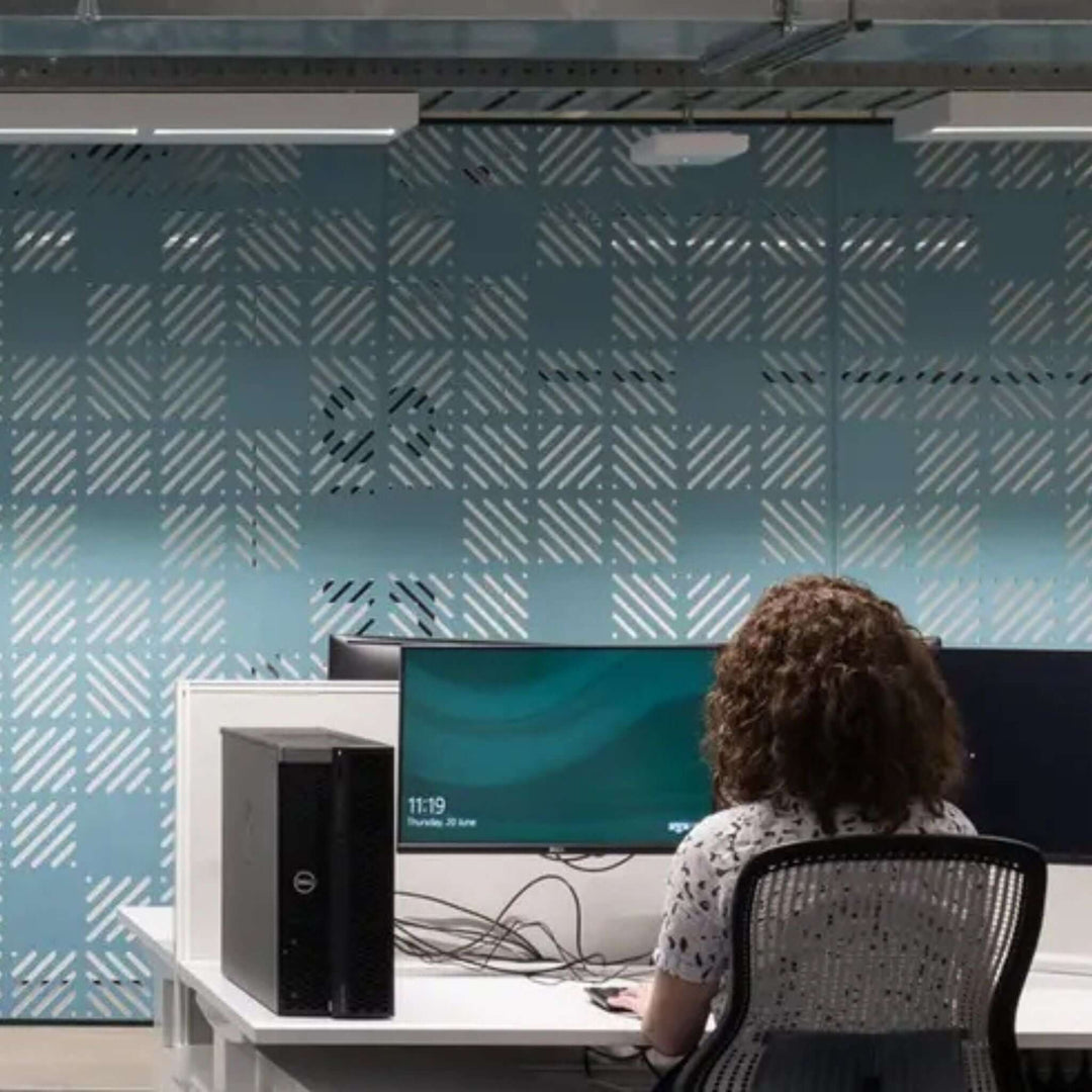 Modern workspace featuring Autex Cascade Hanging Screens for noise reduction and privacy in an open-plan office setting.