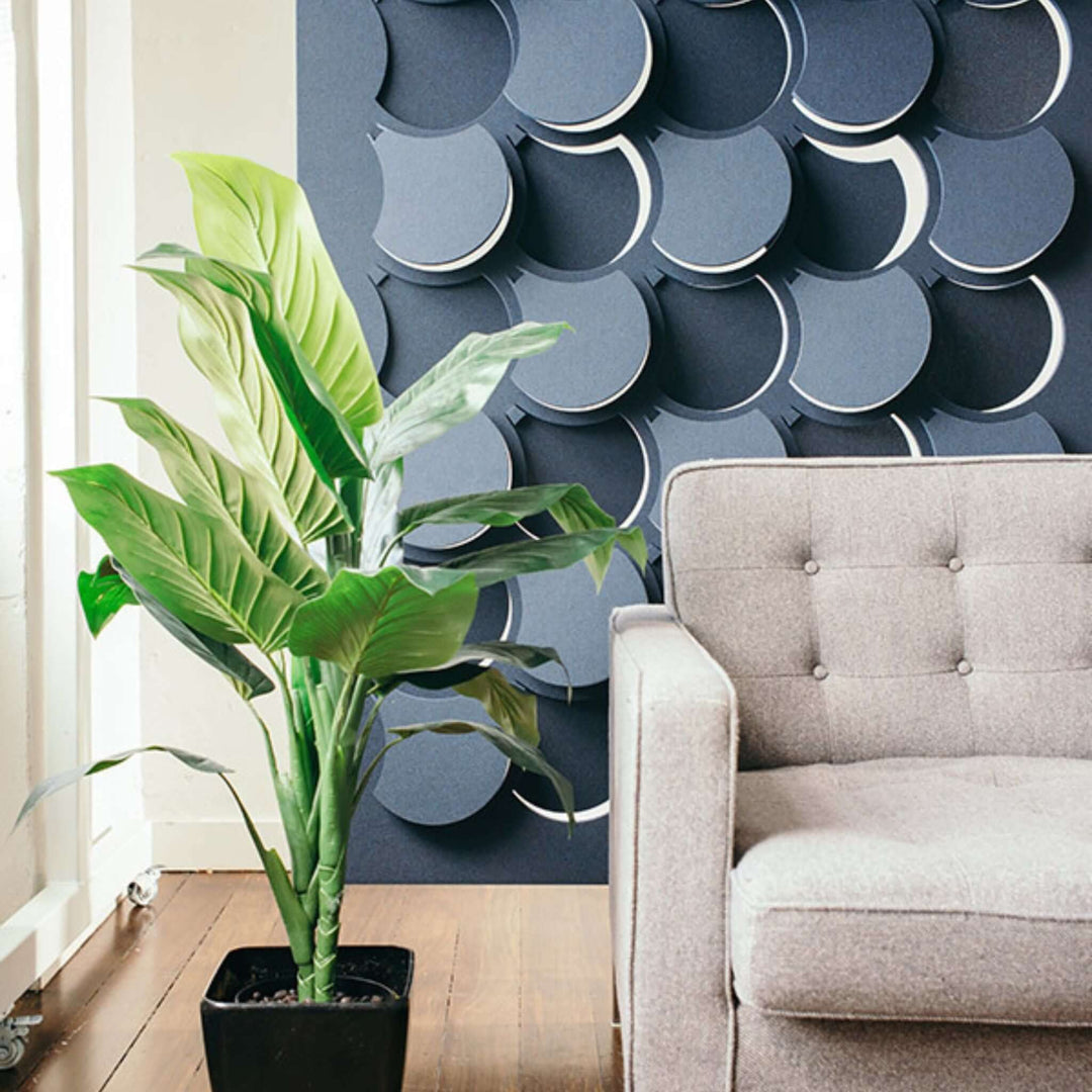 Autex Cascade hanging acoustic screens in a modern office with a plant and a stylish sofa for enhanced aesthetics.