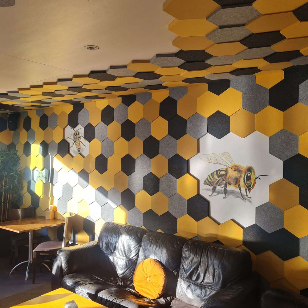 Interior view showcasing Cube™ Honeycomb Acoustic Tiles in yellow and gray, enhancing sound absorption and decor.