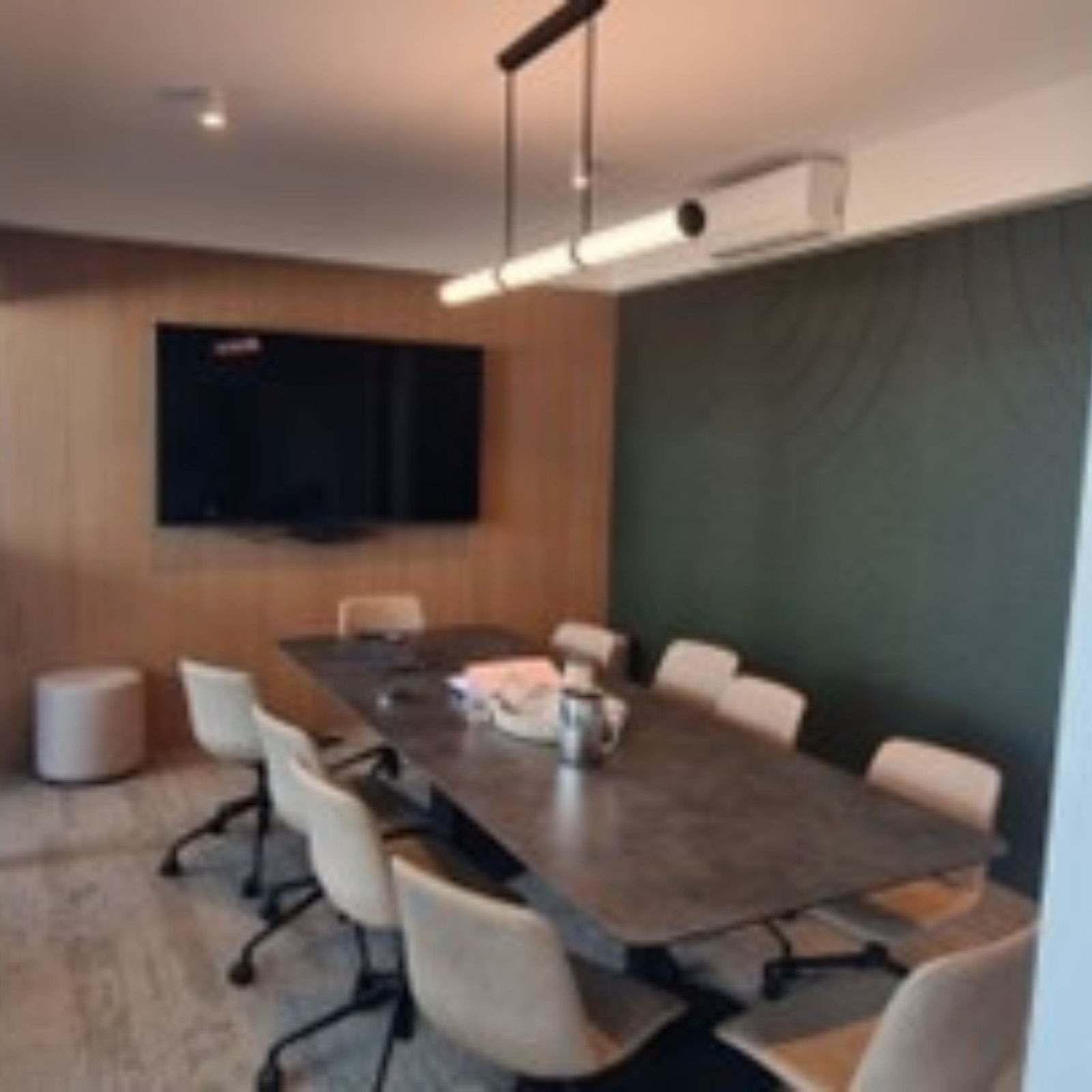 modern conference room with table, chairs, TV, and air conditioning in Australian showroom