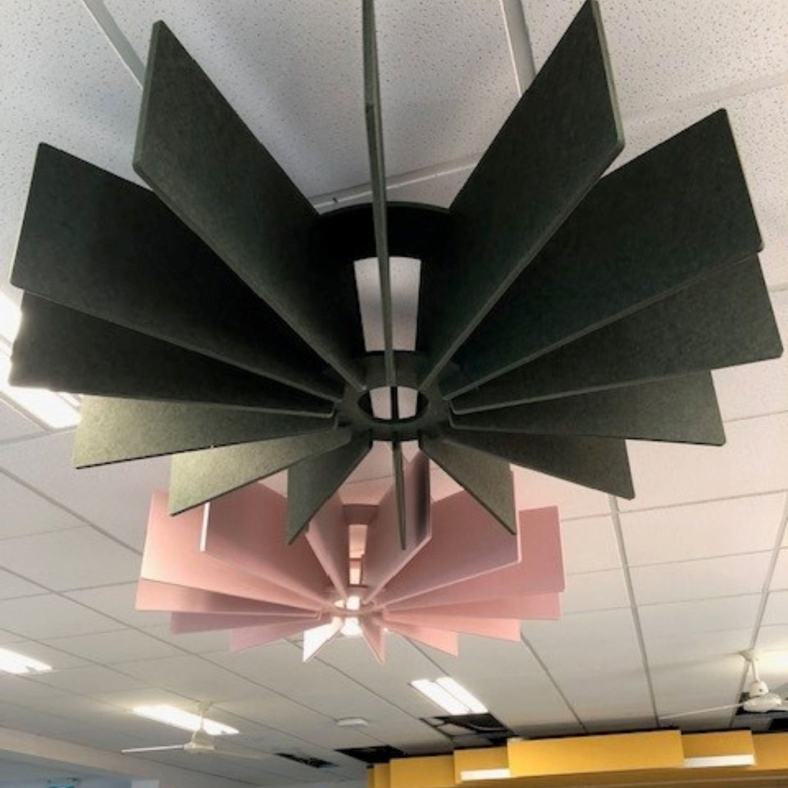 acoustic panels in green and pink design hanging in Holy Trinity Primary School's learning centre for better sound control.