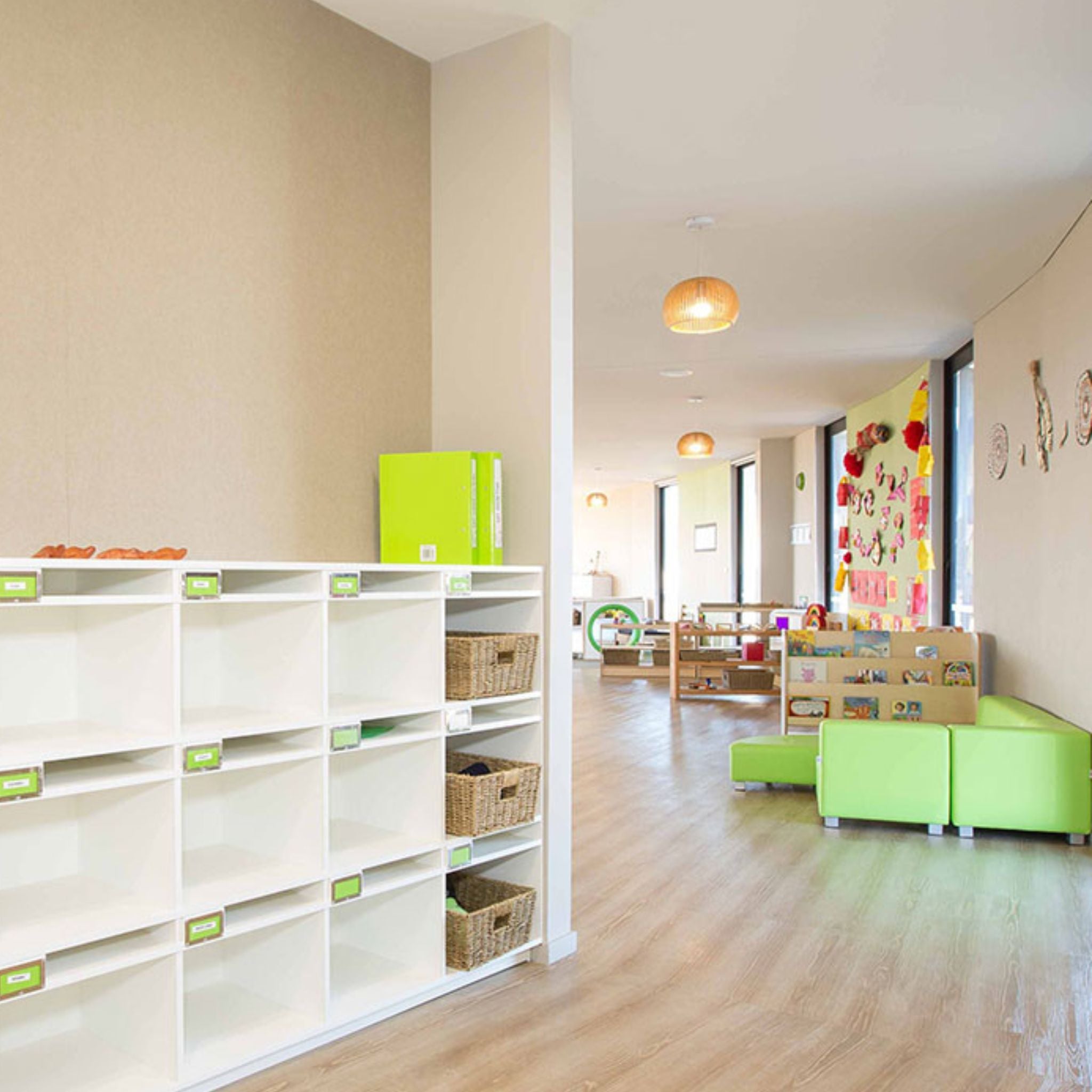 Modern classroom interior featuring acoustic wall covering and vibrant furniture for soundproofing and style.