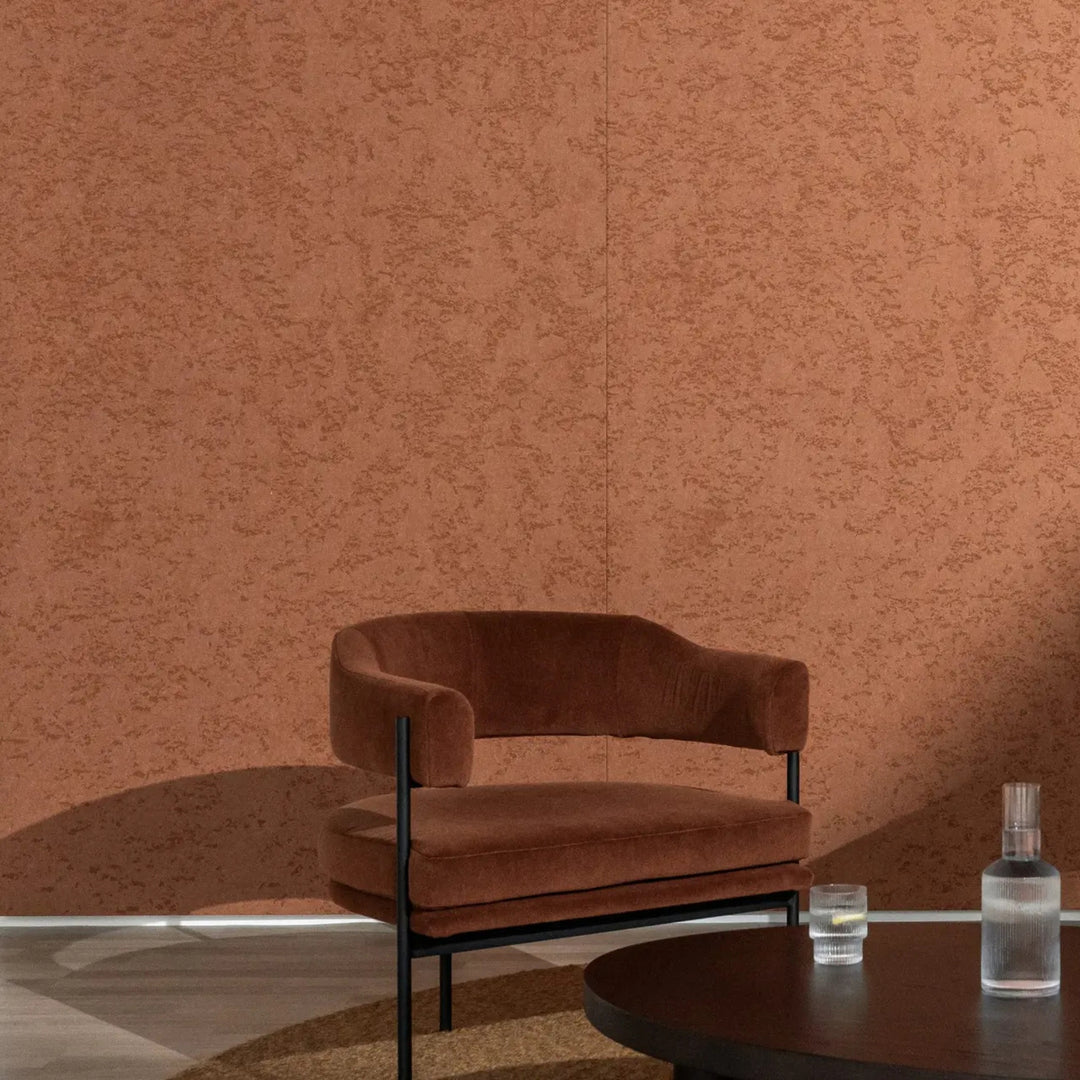 Autex Mirage™ textured panel in warm brown adding dimension to a modern interior with a cozy chair and coffee table.