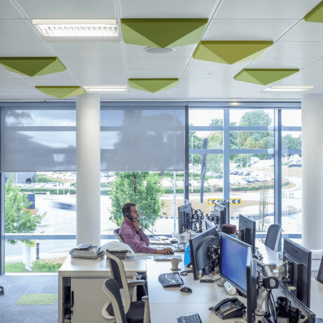 Office space featuring Autex 3D Acoustic Ceiling Tiles in green, enhancing sound absorption and design.