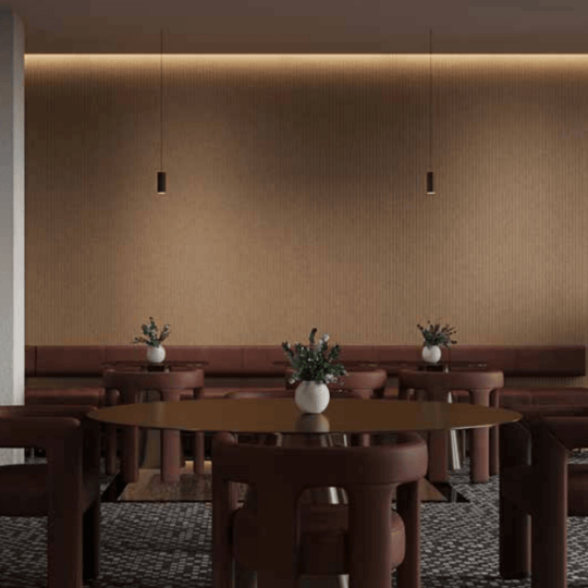 Acoufelt QuietForm™ 3D debossed acoustic tiles in a modern interior setting with stylish furniture and warm lighting.