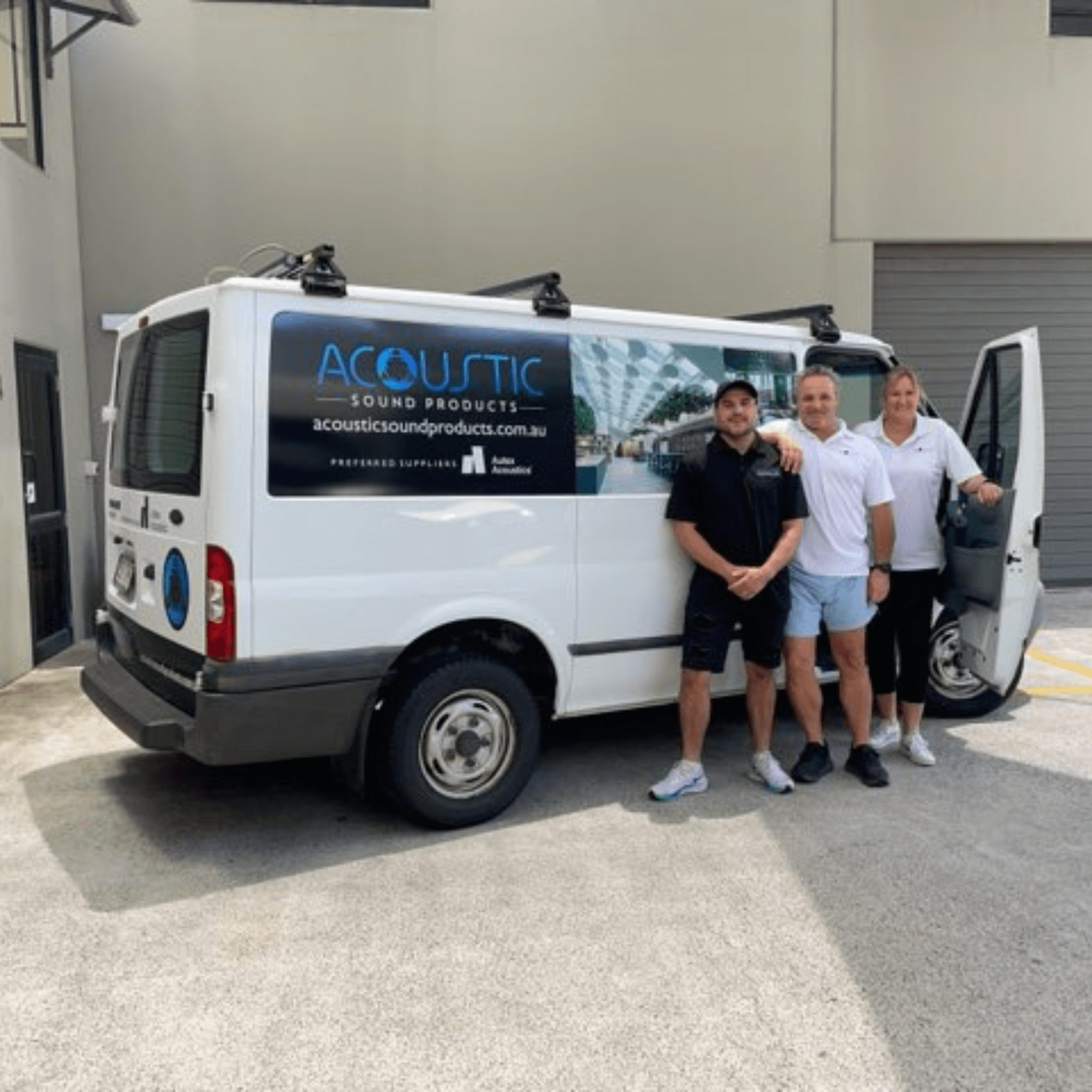 Team members standing beside an Acoustic Sound Products van outside their facility in Australia.