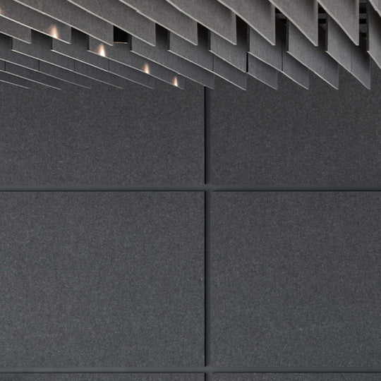 Dark textured wall featuring Autex Cube™ Acoustic Panels for superior sound absorption and modern interior design.