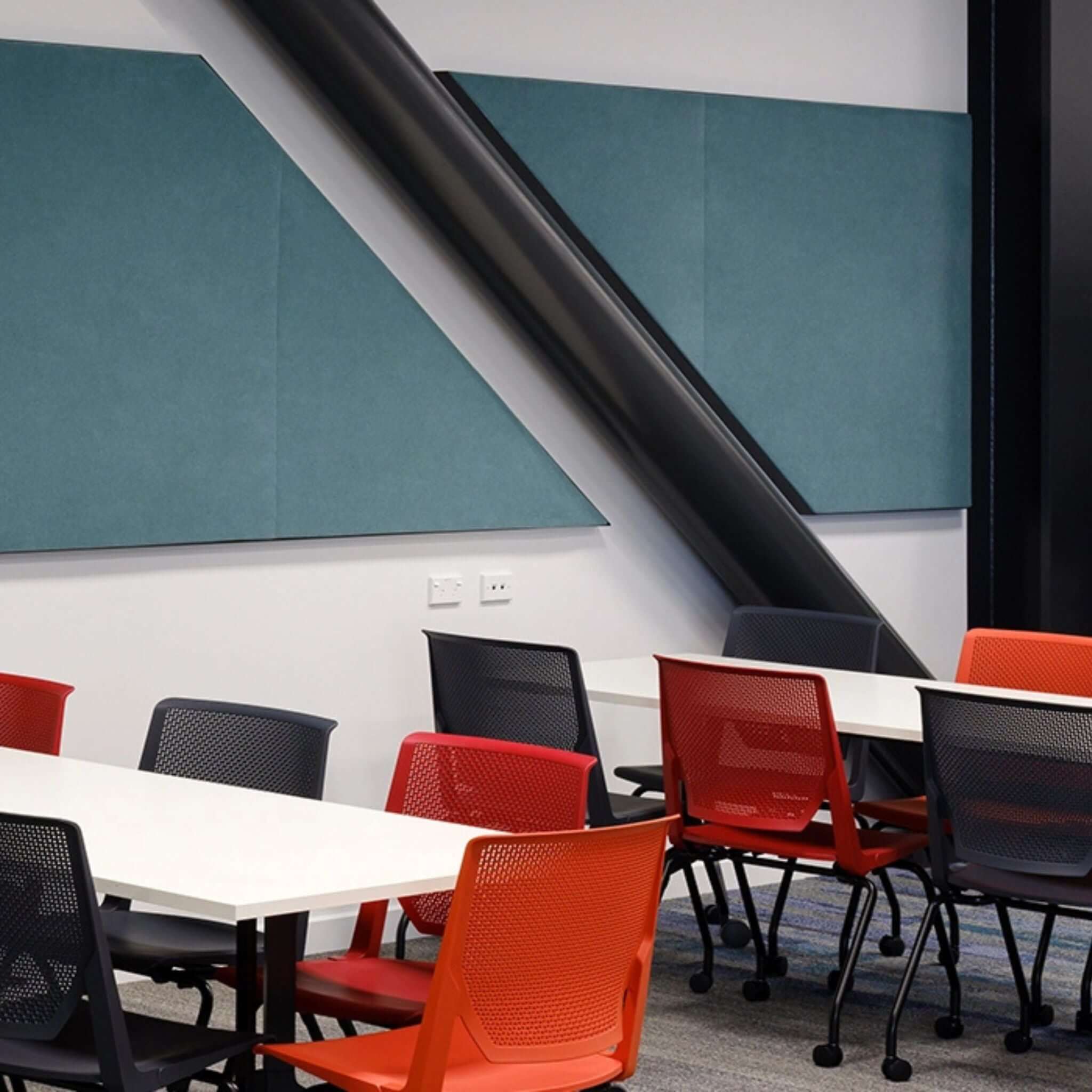 Autex Quietspace acoustic panels installed in a modern office setting with colorful chairs and contemporary decor.