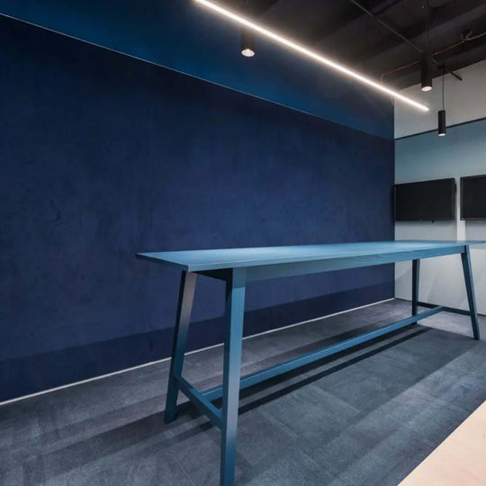 Autex Vertiface Acoustic Fabric wallcovering in a modern interior with blue table and sleek furnishings.