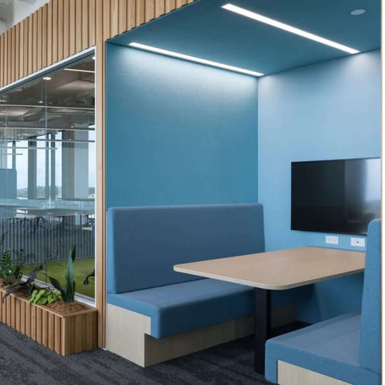 Modern blue acoustic booth with a sleek design, showcasing Autex Vertiface fabric wallcovering in an office space.