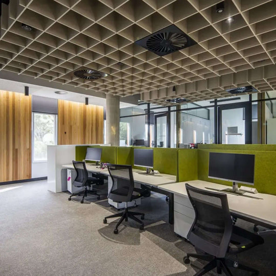 Modern office with stylish acoustic fins and ergonomic workstations for noise control and comfort.