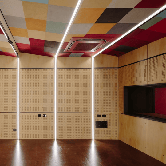 Colorful ceiling of a modern room featuring Autex Peel n Stick acoustic tiles for sound dampening and aesthetic appeal.