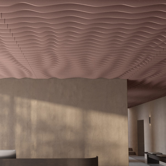 A modern interior space featuring a wavy, ribbed acoustic ceiling panel in a dusty rose pink color, mounted above a textured beige wall.