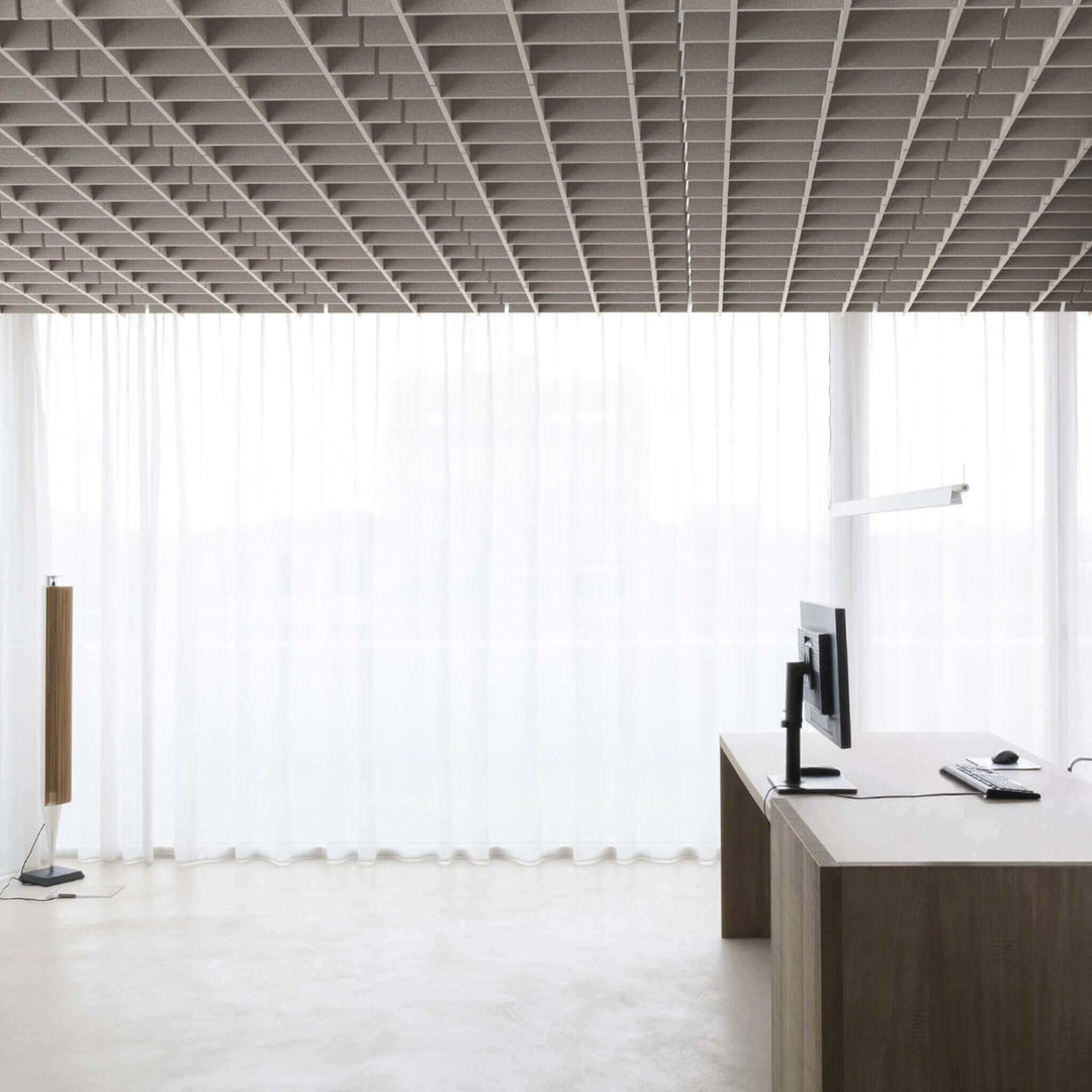 Modern office interior featuring Autex Grid Ceiling Tiles and large windows with sheer curtains.