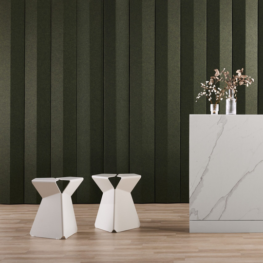 Modern interior featuring Autex Lanes™ acoustic panels with minimalist stools and a marble countertop.