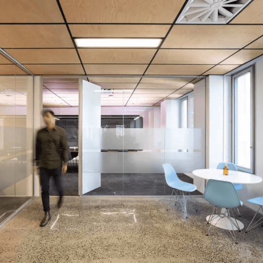 Modern office interior featuring Autex Acoustic Timber ceiling tiles and contemporary furniture.