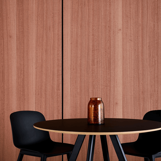 Modern dining setup featuring Autex Acoustic Timber Panels with a wooden table and black chairs, showcasing premium woodgrain finish.