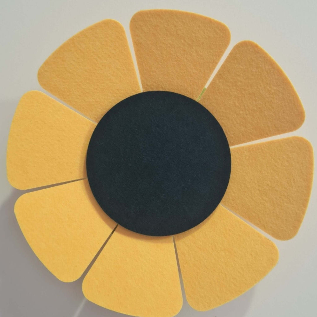 Acoustek WallFlower 3D acoustic wall panel in a floral design with yellow petals and a black center, ideal for noise reduction.